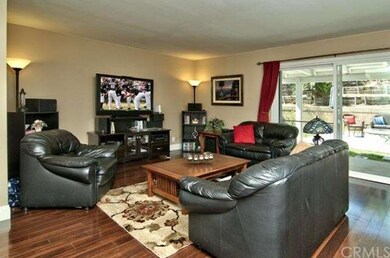 Spacious Living Room Enjoys Patio and Backyard Vie