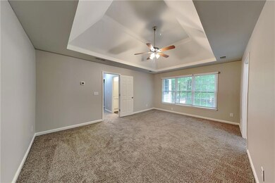 Unfurnished room with a raised ceiling, ceiling fa