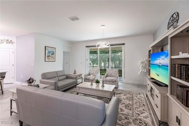 Living room with a chandelier and light tile patterned floors