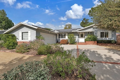 Exterior Front  
Front door with glass inserts
Covered brick entry
Eco-friendly landscaping (2022)
Colorful raised brick flowerbeds
Lush greenery
Manicured hedges
Winding walkways
Mature shade and fruit trees (Pomegranate& Mandarin Orange)
B