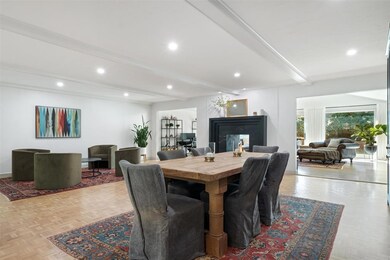 Dining room with beamed ceiling, a high end firepl