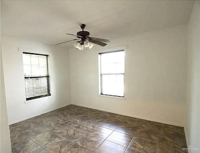 Spare room featuring a ceiling fan