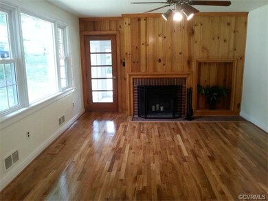 ** Living Room, fireplace, wood wall, door to Fla. Room, New hardwood floors !!