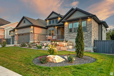 Craftsman-style home with stone siding and a garage