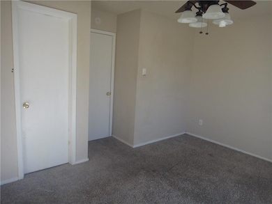 Spare room with carpet floors, a ceiling fan, and 