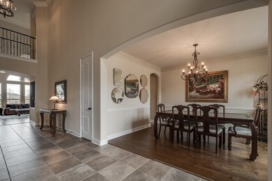 Large formal dining room features beautiful iron chandelier and gorgeous hardwoods!