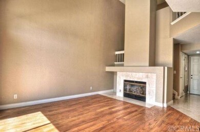 Living room features cozy fireplace with travertin
