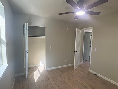 Unfurnished bedroom featuring light wood-type flooring, a ceiling fan, and a closet