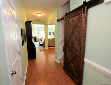 Nice foyer, barn door leads to bonus room over the garage