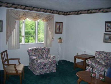 Living Room. Bright living room has ample wall spa