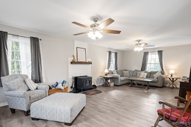Living area featuring a wood stove, wood finished