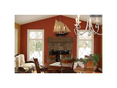 Vaulted hearth room has wood-burning stone firepla