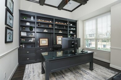 Executive  study/office has wood floors, coffered ceiling, built-in bookshelves and file drawers. Desk matches the built-ins and will convey.