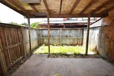 Fenced backyard with a patio area