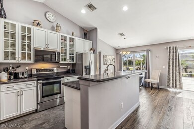 Featuring vaulted ceiling, dark tone countertops,