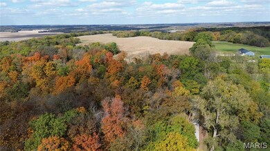 Aerial view of property's location with a forest
