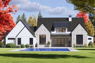 Back of property with board and batten siding, a standing seam roof, a yard, and metal roof