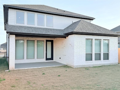 Back of property featuring roof with shingles, br