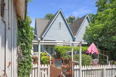 A VIEW OF THER BACK OF THE COTTAGE, PICKET FENCES,