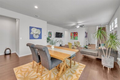 Dining area featuring wood finished floors, a cei