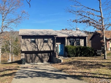 Raised ranch with driveway and a garage