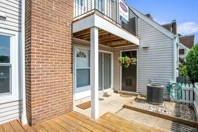 Front deck with front door and storage area door.