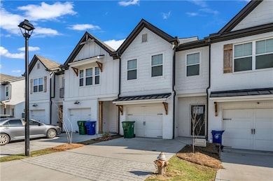 View of property with concrete driveway, brick sid
