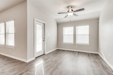 Empty room featuring light wood finished floors and ceiling fan