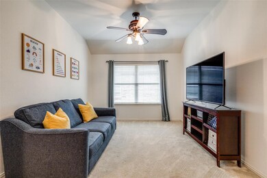 Living area with ceiling fan, light carpet, lofted