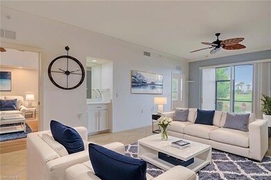 Living area featuring a ceiling fan, light tile patterned flooring, and crown molding