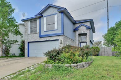 View of front of home featuring brick siding, driveway, and an attached garage
