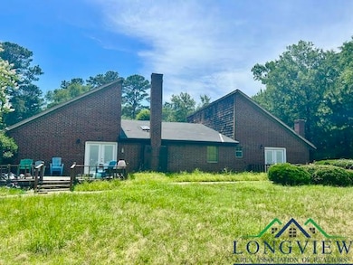Back of house with french doors, a wooden deck, brick siding, and a chimney