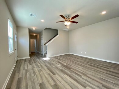Unfurnished living room featuring stairs, a ceili