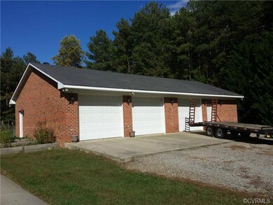 All brick 3+ car garage with a work shop area