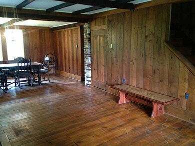 Living Room. Wide plank floors, wood paneling, bea