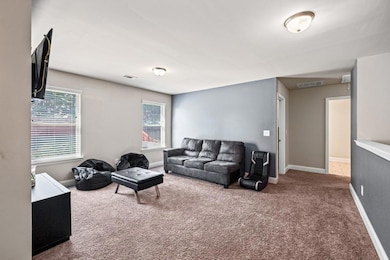 Living area with carpet floors, visible vents, and