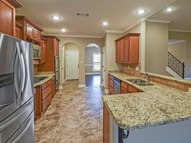 This is a dream kitchen.  The design places everything within reach without crowding.  Stainless appliances including 5-burner gas cooktop,double ovens,microwave and pot filler make this kitchen just perfect.