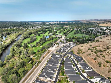 View of property location featuring a large body of water and nearby suburban area