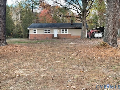 Single story home with crawl space, a carport, a chimney, and brick siding