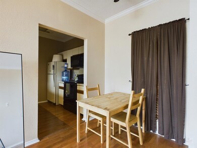 Dining area featuring crown molding and wood fini