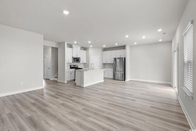 Unfurnished living room featuring light wood-style floors and recessed lighting