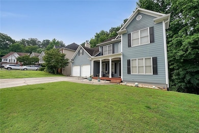 Traditional home with a porch, concrete driveway, a front lawn, and a chimney