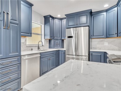Kitchen featuring backsplash, sink, stainless stee