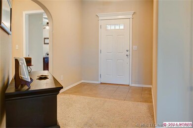 Looking back at entry door and tile. Inviting arch