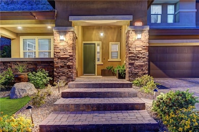 Entrance to property with stone siding, stucco sid