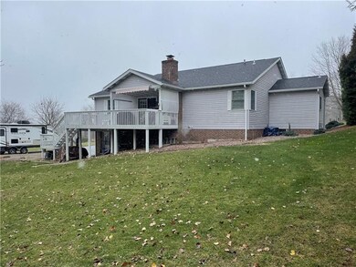 Large covered deck with addition roll out awning and stairs to side yard.