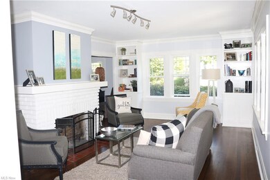 Living room filled with natural light, fireplace and custom built-ins