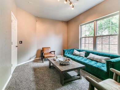 Carpeted living area featuring baseboards