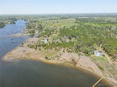 Aerial view featuring a water view and a wooded view