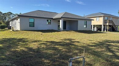 Rear view of house featuring stucco siding, a shin